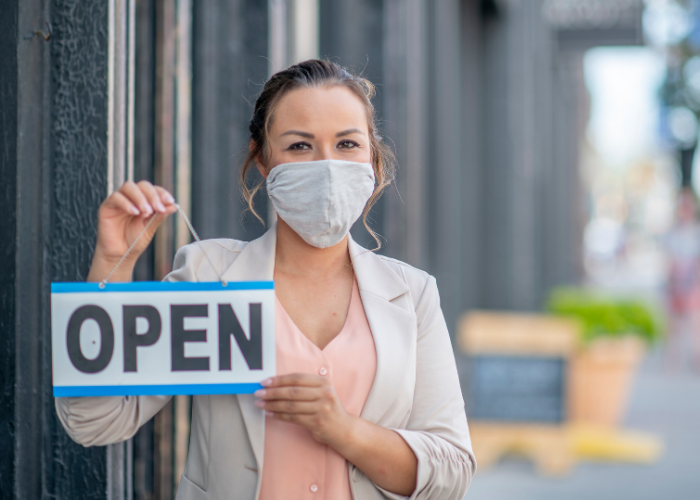 Woman with mask and 'open' sign