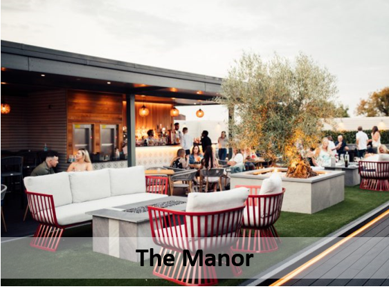 The Manor's rooftop bar, with people sitting on white sofas and at the bar