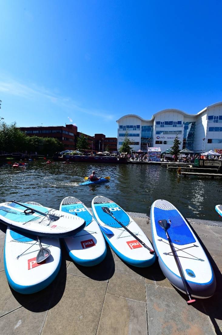 Stand up paddle boards stacked on the side of Aylesbury canal basin