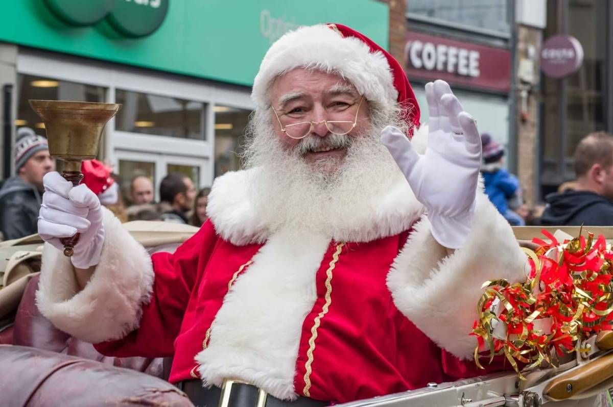 Smiling santa in his sleigh on Santa Sunday Parade